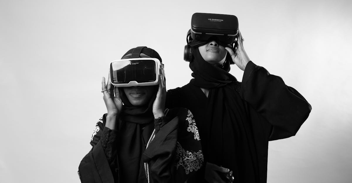 Two women in traditional attire enjoying virtual reality, showcasing modern technology.